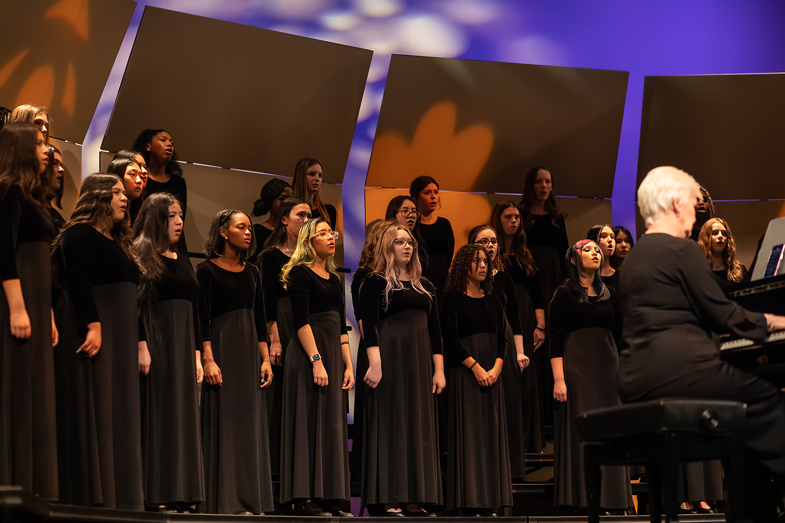 Concert Chorale performance with warm stage lighting